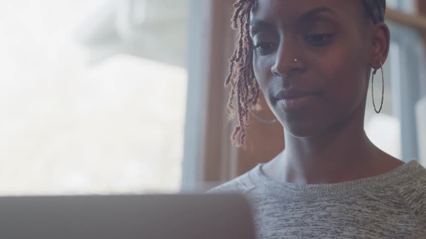 A woman reading something on a screen