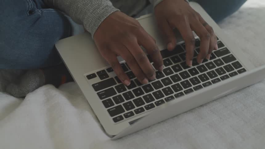 A person typing on a laptop