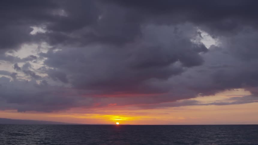 The sun setting over the ocean