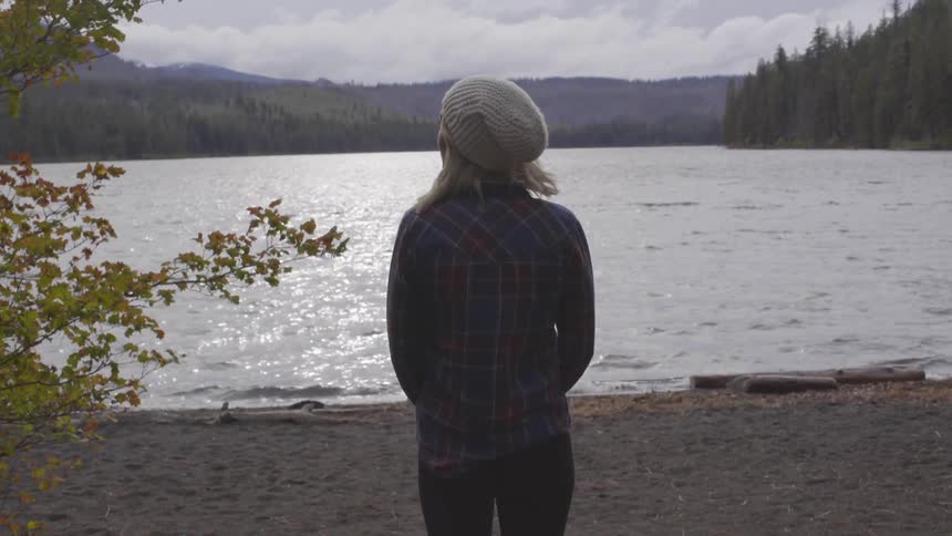 Female walking toward lake