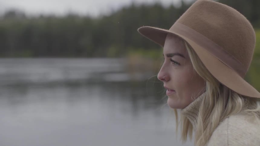 Girl sitting next to river