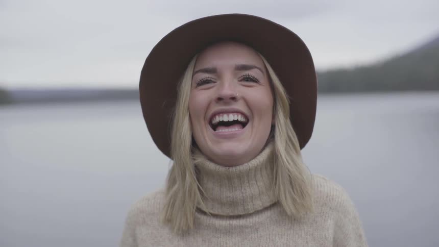 Woman facing camera laughs