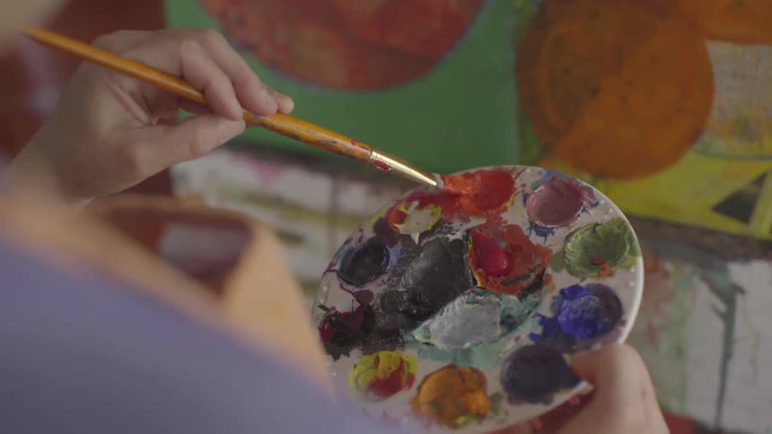 A woman painting on a canvas