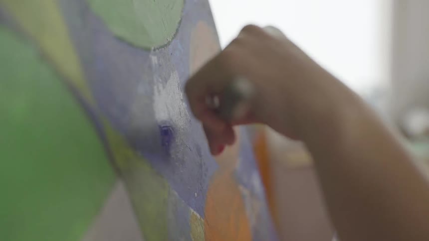 Painter applying paint with spatula