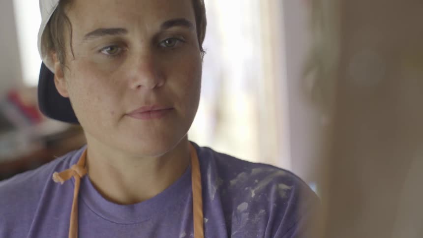 Girl wearing a shirt covered in paint