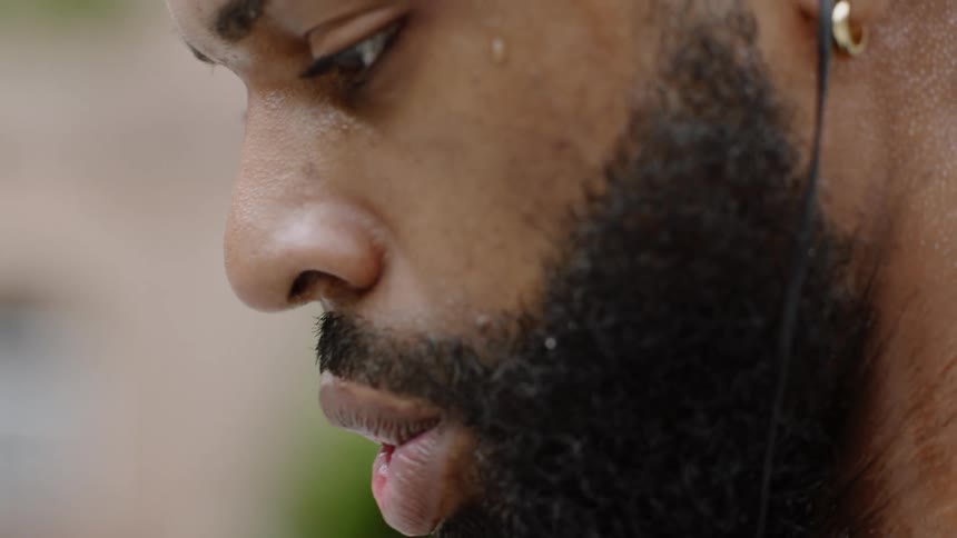 A man looks down while he sweats