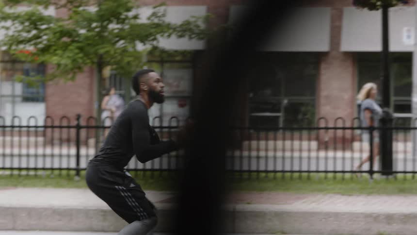 A man plays basketball outside
