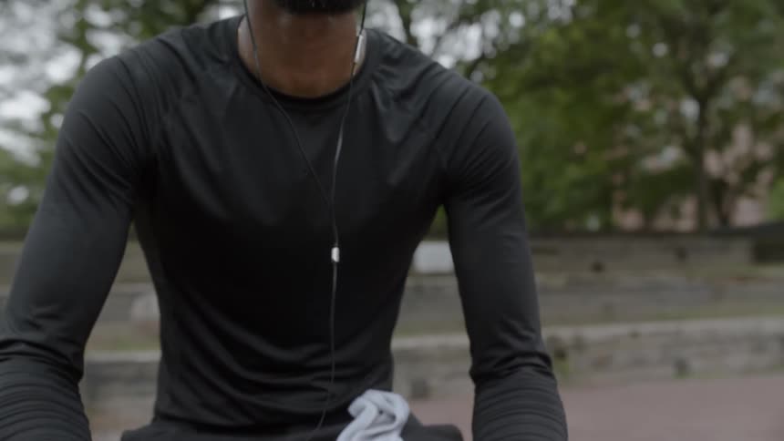 A man holds a basketball while listening to music