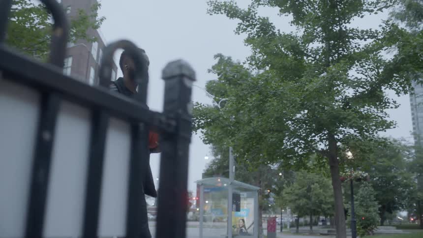 Black man entering in a public park holding a basketball