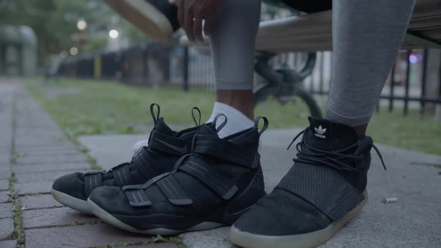 A man removes a shoe to replace it with another