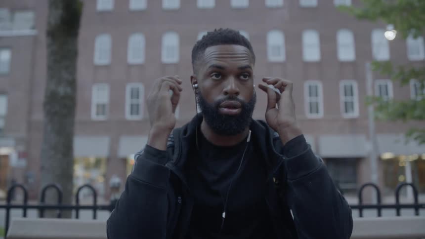 Black man putting in headphones