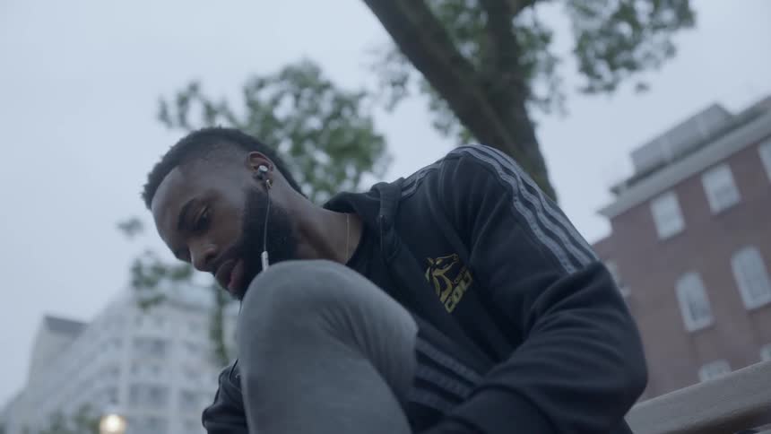 A man bends down and stretches his leg