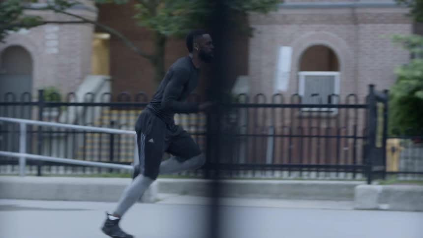 A young black man is sprinting