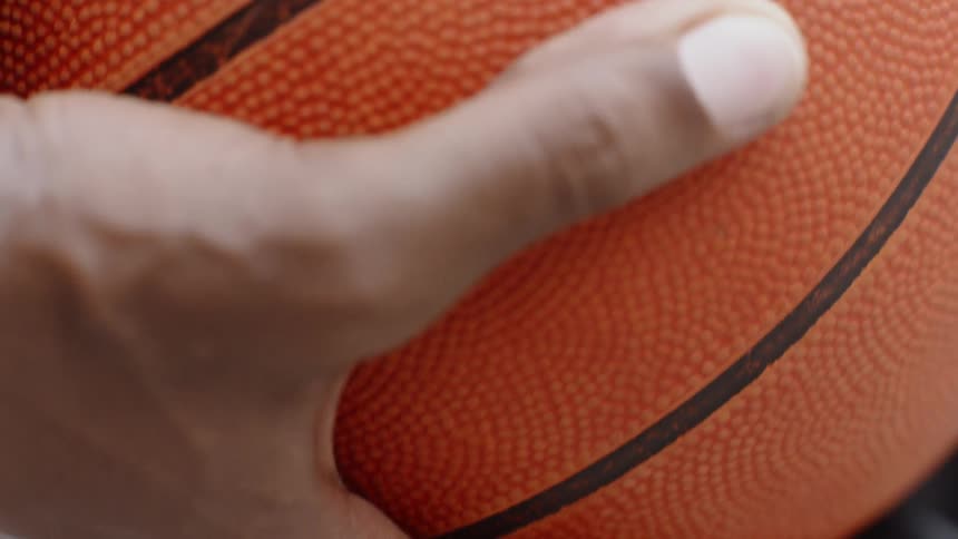 Hand holding a basketball