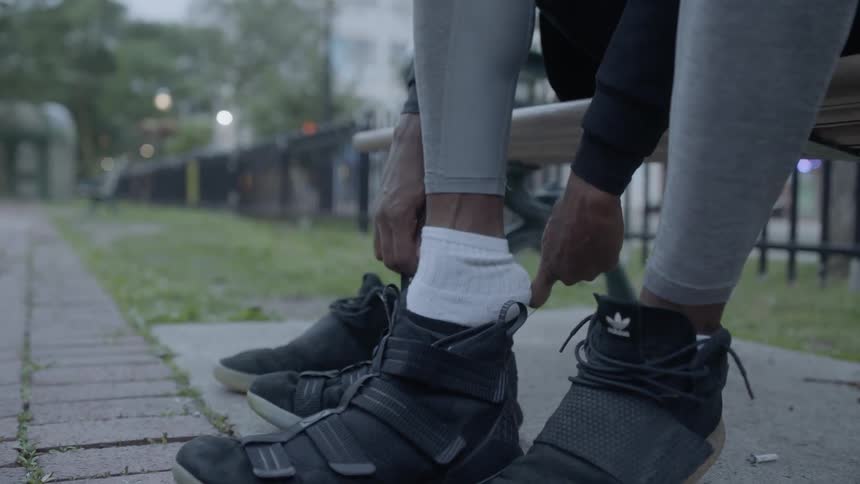 A person putting on their sneaker