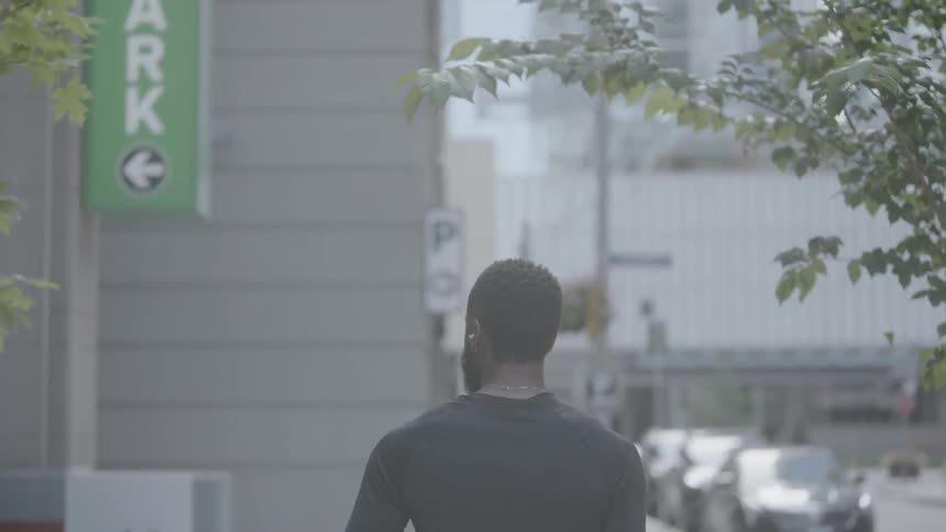 A man walks down the sidewalk