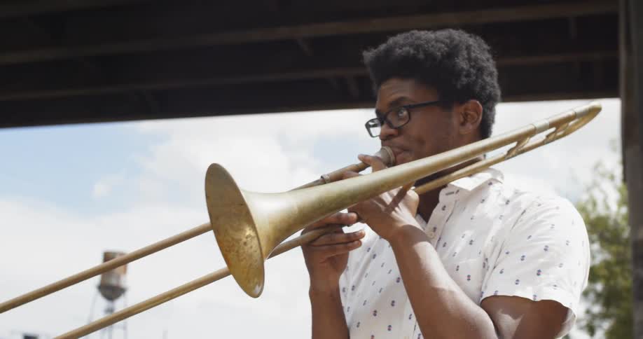 Two young men play brass instruments