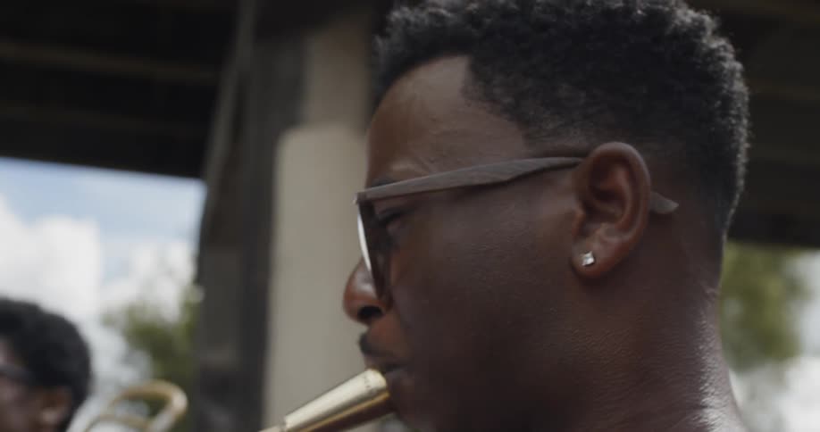 Musicians playing brass instruments under and overpass