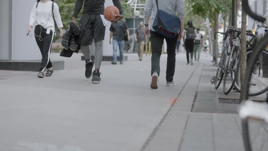 People walking down a sidewalk