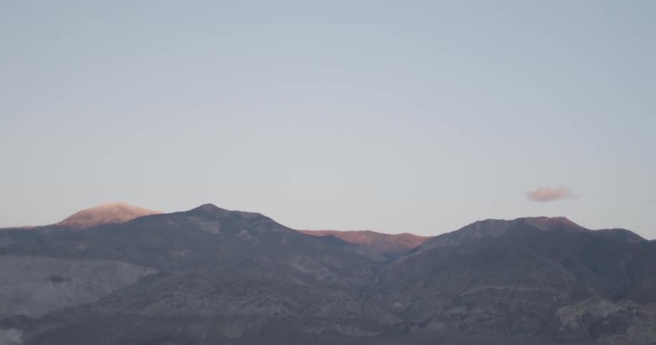 Mountain range sits under clear sky