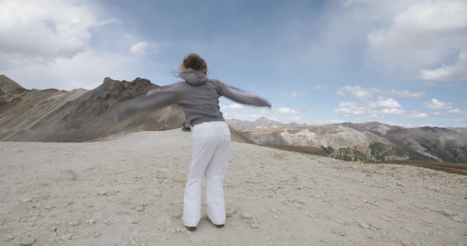 A woman jumping in the air on a trail
