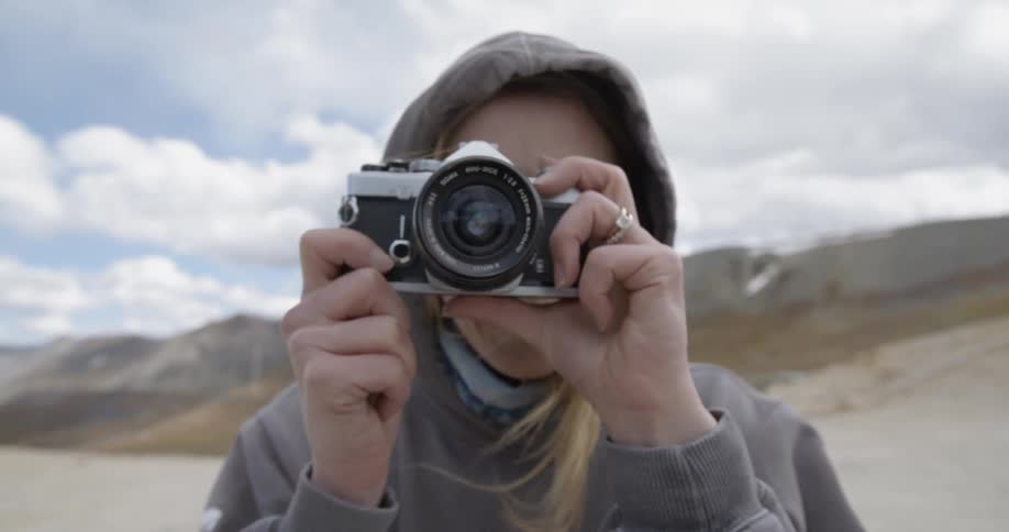 Woman lifts camera and takes picture