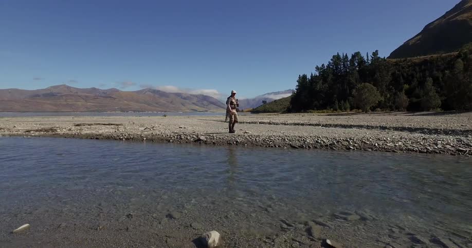 A man  walking past a river
