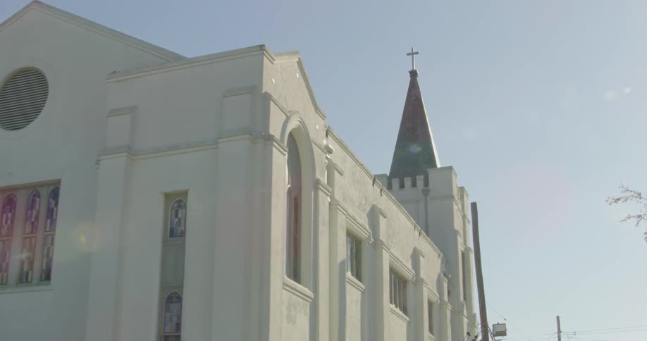 Camera goes down a city street looking towards a church