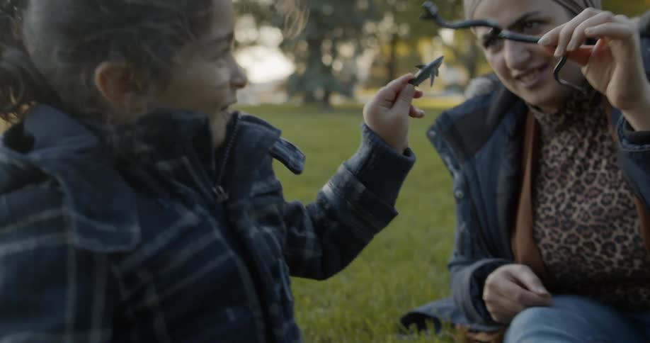 Two people playing with a rubber snake