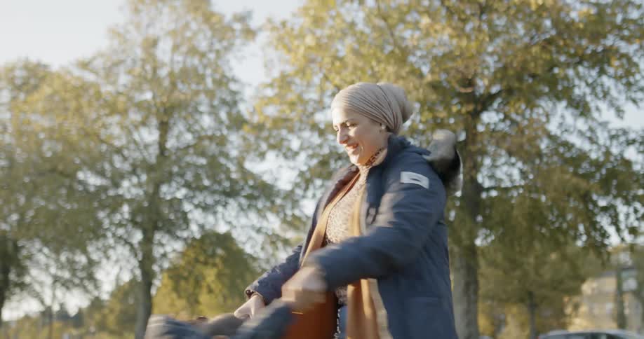 Mother and daughter spinning in a park
