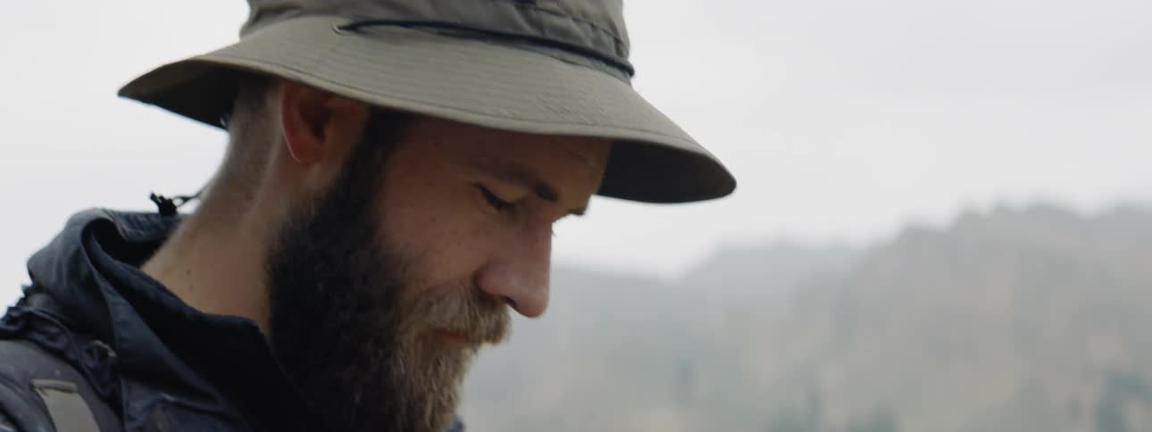 Man looks up and down while out in nature