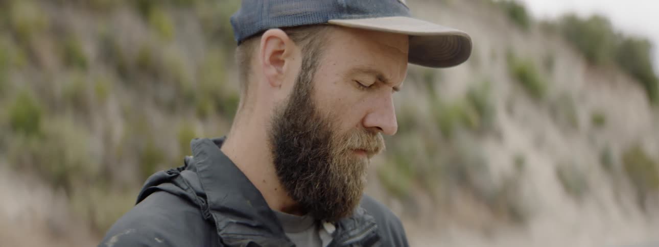 Man looking thru a lens in a field