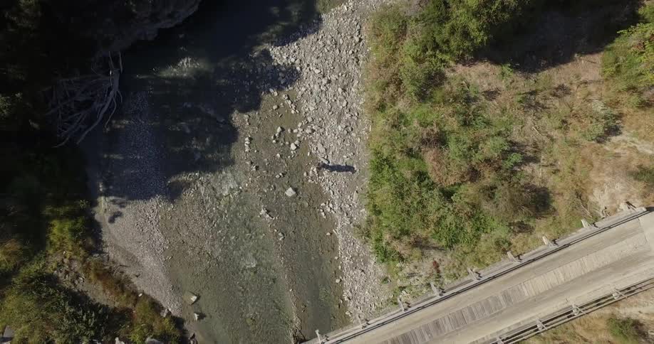 A person traveling along a stream on a sunny day