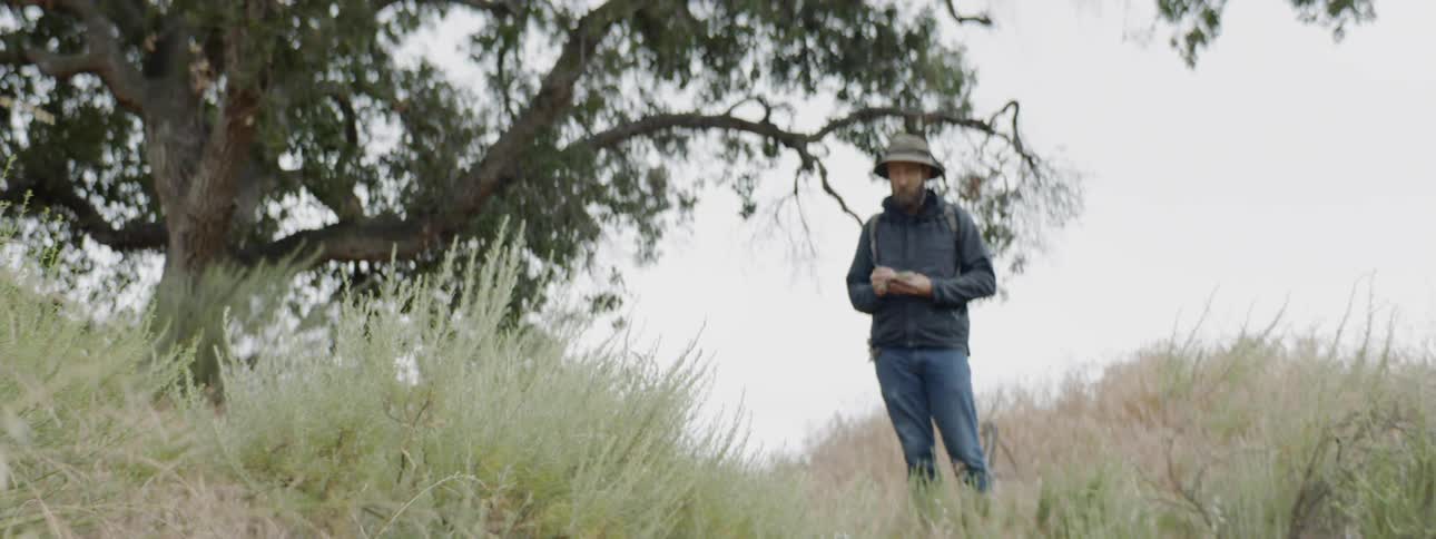 Man standing next to a tree
