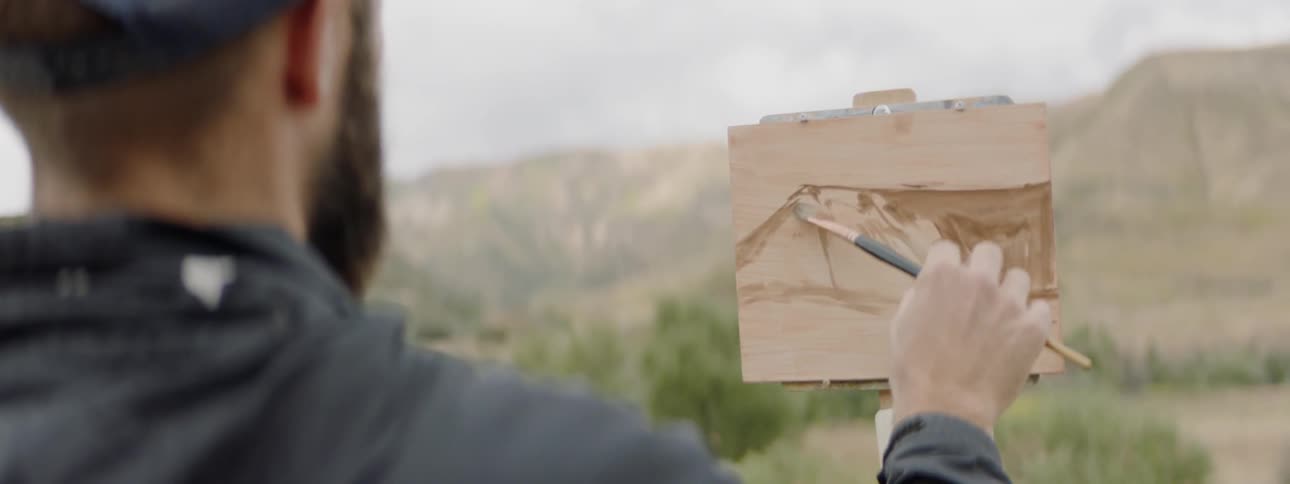 An artist painting a picture outside