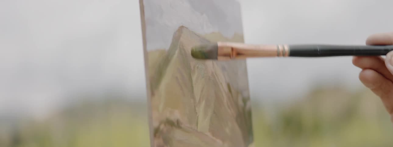 Person painting mountain