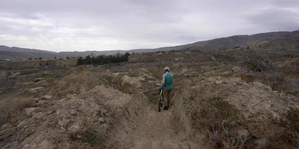 A person walking their bike