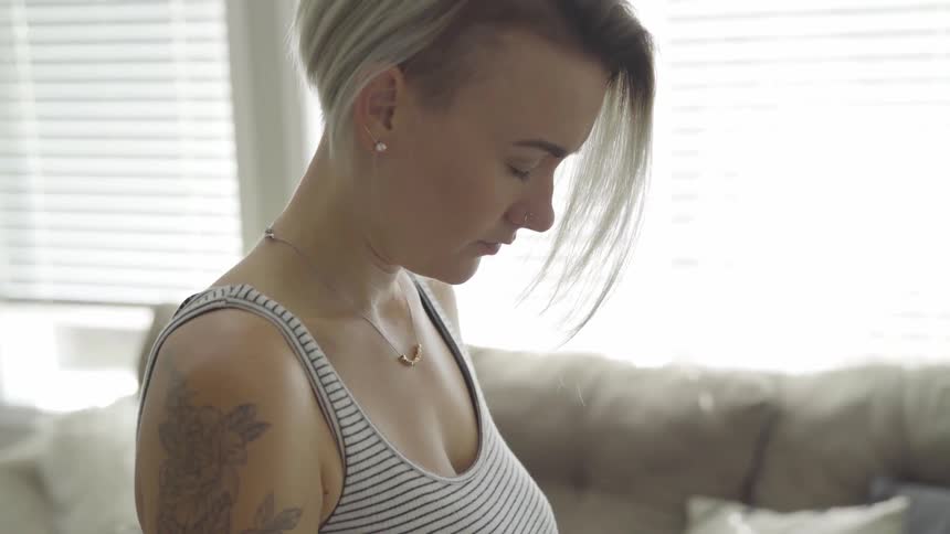 Woman bowing her head and closing her eyes