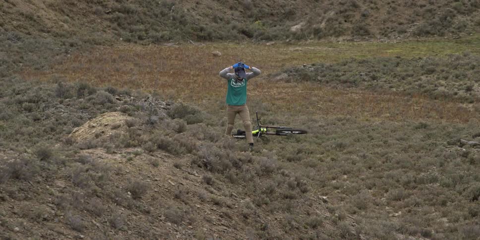 A bmx rider dismounts his bike