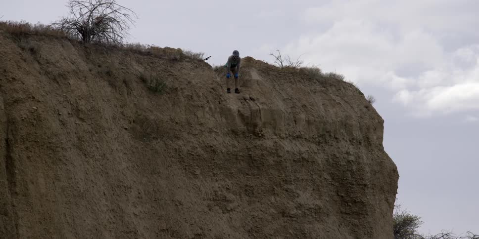 A person is looking over a cliff