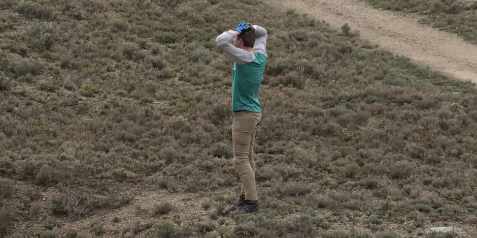 A man is stretching in a field