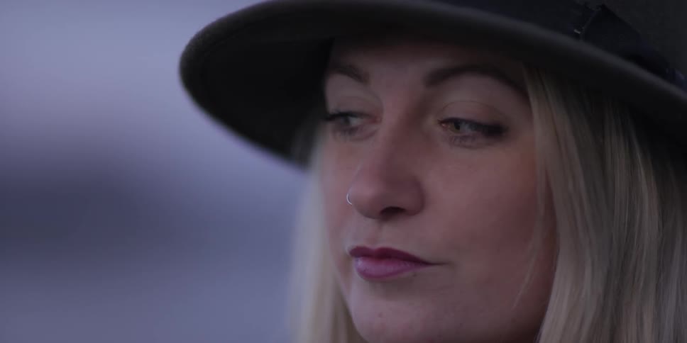 A woman looks off into the distance