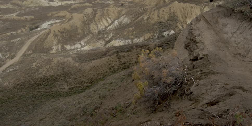 A man has a bad landing while attempting to do a flip on his mountain bike in the mountains