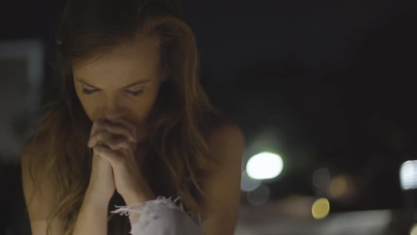 Girl praying at a table
