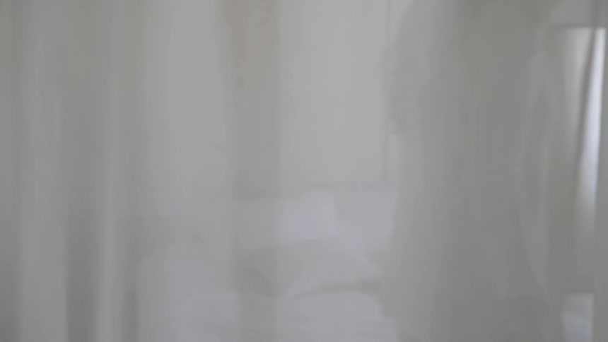 A woman walking in a bedroom