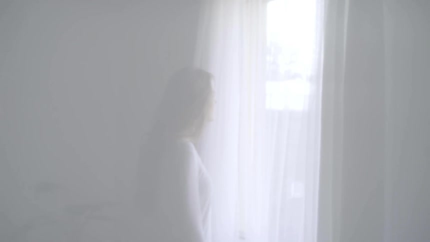 A woman is looking out the window