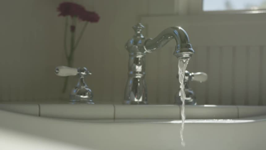 Water pouring from faucet into bathtub