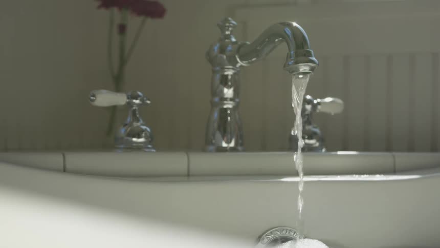 Water is pouring from a faucet