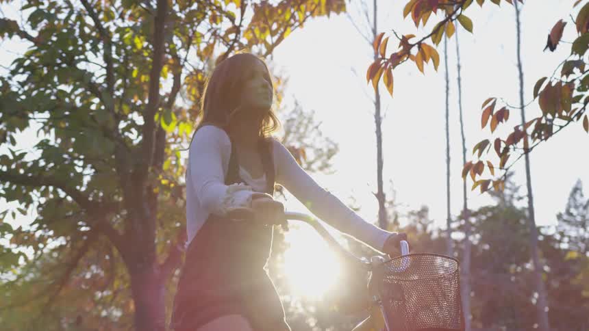 Female sitting on a bike enjoying nature surrounding her