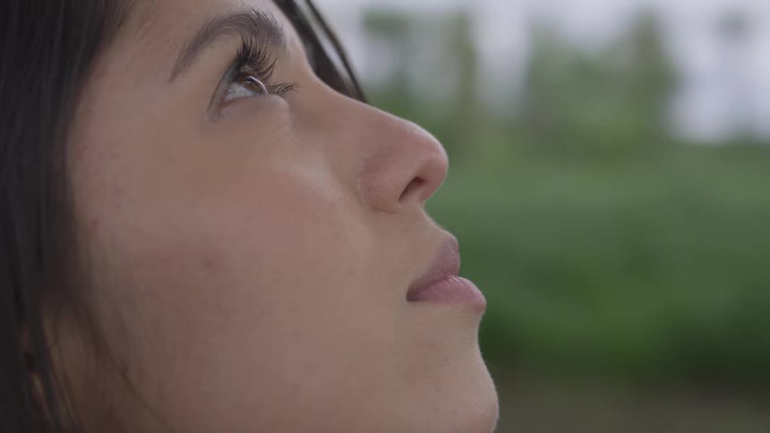 Woman looks up towards the sky